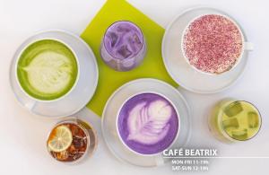 four cups of different colored drinks on a table at Hotel Merkur - Czech Leading Hotels in Prague