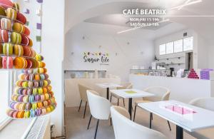 a restaurant with white tables and chairs and a vase at Hotel Merkur - Czech Leading Hotels in Prague