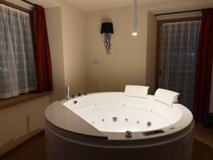 a large white tub in a room with windows at Lo Berio Morgex in Morgex