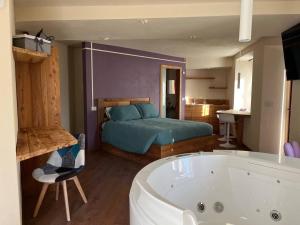 a bedroom with a bed and a bath tub and a bath tub at Lo Berio Morgex in Morgex