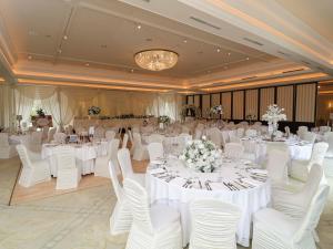 a banquet hall with white tables and white chairs at Nuremore Estate in Carrickmacross +27 photos