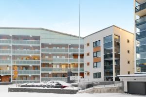 a building with a car parked in front of it at Modern Arctic Studio By Lapland Host in Rovaniemi
