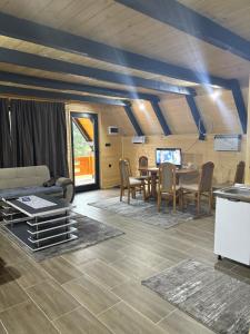 a living room with a couch and a table at ROMANIJA vikendice in Sarajevo