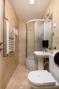 a bathroom with a toilet and a sink and a shower at One Luxury Suites AKUSTIK - 3 minuta peške do Jezera in Zlatibor +79 photos