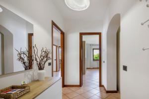 a kitchen with white walls and a hallway with mirrors at La Veranda - Alpago in Pieve dʼAlpago