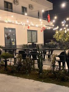 a restaurant with tables and chairs and lights at B&B Mastro Mario in Rocca di Neto
