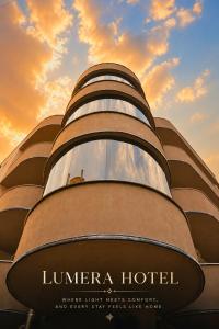 a building with a sunset in the background at Lumera Hotel in Durrës