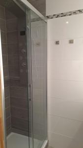 a shower with a glass door in a bathroom at Saltwater Hohwacht in Hohwacht +22 photos