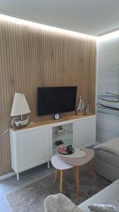 a living room with a tv and a coffee table at Saltwater Hohwacht in Hohwacht