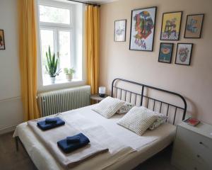 a bedroom with a bed with two towels on it at Garsonka - Luhačovice in Luhačovice