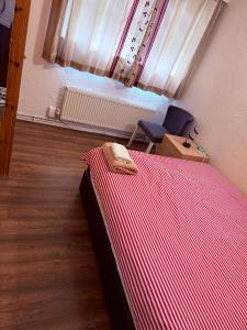 a bedroom with a bed and a chair and a window at Andover Bungalow in Penton Mewsey