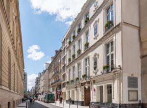 a street in a city with buildings at Hotel Malte - Astotel in Paris