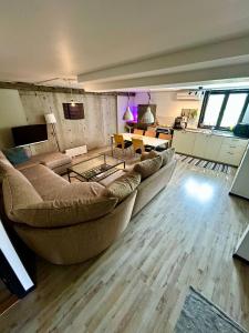a living room with a large couch and a table at Halek Hem - Haga loft in Enånger