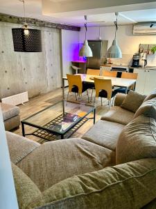 a living room with a couch and a table at Halek Hem - Haga loft in Enånger