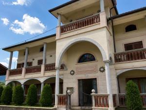 a large building with a balcony on top of it at Villa Nona with swimming pool in Dornberk
