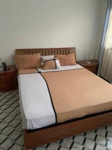 a bedroom with a large bed with two pillows at Le Wallo - Residence Sebi in Sébikhoutane