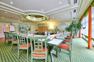 a row of tables and chairs in a restaurant at Hotel Linderhof in Erfurt