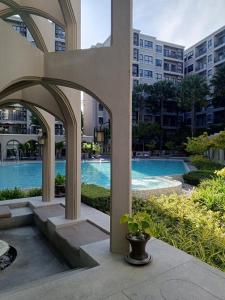 a view of a swimming pool in a building at Exclusive Condo with Pool - Self Check-in in Hua Hin