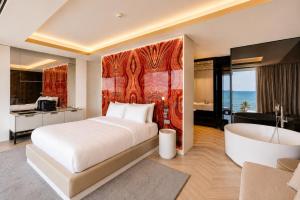 a bedroom with a large bed and a bath tub at Hotel Villa Pascucci Mare in Durrës