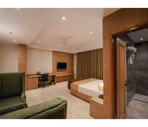 a hotel room with a bed and a desk at Sagar Resort in Alwar