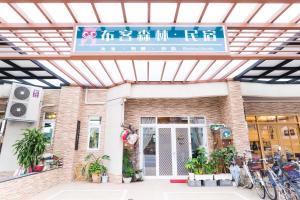 a building with a sign in front of it at Books & Woods Bed and Breakfast in Taitung City