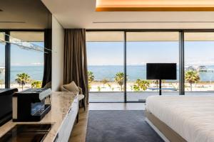 a hotel room with a bed and a view of the ocean at Hotel Villa Pascucci Mare in Durrës