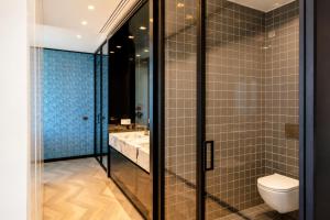 a bathroom with a toilet and a sink and a mirror at Hotel Villa Pascucci Mare in Durrës +23 photos