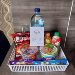 a drawer with a bottle of water and other snacks at Hotel Grand Ansara Mentari in Baturaja