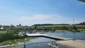 a large swimming pool with people in the water at Tinyhouse am Bach, 3144 Wald in Wald +8 photos