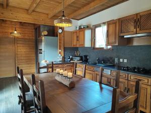a kitchen with a wooden table with candles on it at Le Châlet Nature de Lieurey in Lieurey