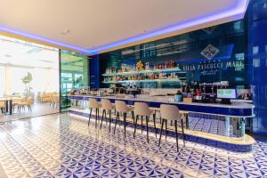 a bar in a restaurant with chairs and tables at Hotel Villa Pascucci Mare in Durrës