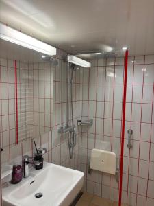 a bathroom with a sink and a mirror at Ferienzimmer Appenzell in Appenzell