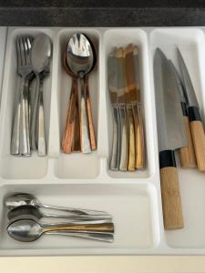 a white tray filled with utensils and silverware at Elite Noua in Braşov