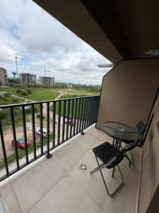 a balcony with a table and a chair on it at Elite Noua in Braşov