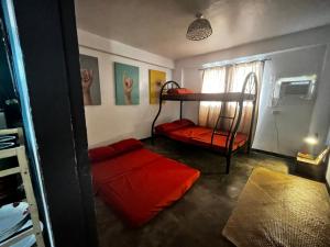 a room with two bunk beds and a window at Art House LU in San Fernando