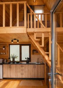 an open kitchen with wooden ceilings and a wooden floor at Kazbegi 4 side cottages in Kazbegi
