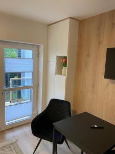 a room with a table and a chair and a window at Natalia 2 in Mrągowo