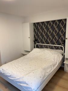 a bed with a metal headboard in a bedroom at Natalia 2 in Mrągowo