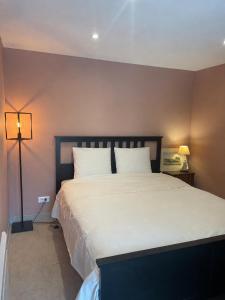 a bedroom with a large bed with two pillows at La rosée in Montanay