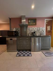 a kitchen with stainless steel appliances in a room at La rosée in Montanay