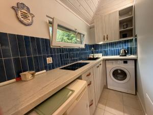 a small kitchen with a washer and dryer at Mini Apart - Gdańsk Jelitkowo in Gdańsk