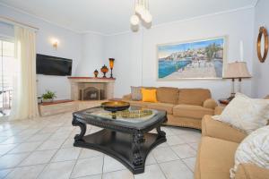 a living room with a couch and a coffee table at Vista Mare I in Porto Heli