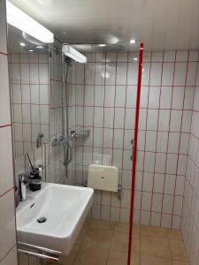 a bathroom with a sink and a shower at Ferienzimmer Appenzell in Appenzell