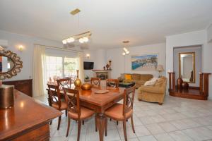 a living room with a wooden table and chairs at Vista Mare I in Porto Heli