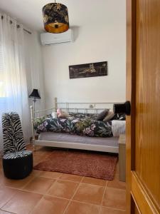 a bedroom with a bed in a room at Mex-Goretti House in Mairena del Aljarafe