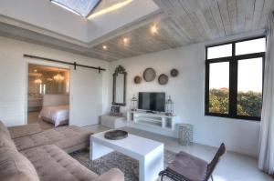 a living room with a couch and a tv at The House Quarters in Kenton on Sea