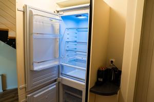 an empty refrigerator with its door open in a kitchen at Arte Brno in Brno