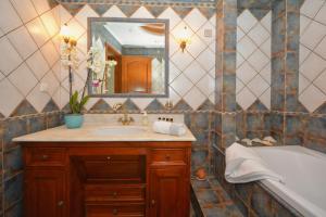 a bathroom with a sink and a mirror and a tub at Vista Mare I in Porto Heli +35 photos