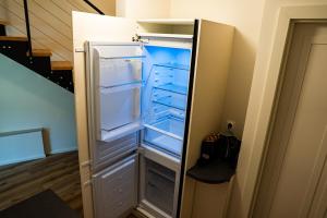an empty refrigerator with its door open in a room at Arte Brno in Brno