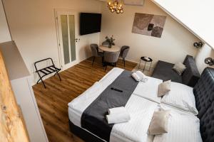 a bedroom with a bed and a table and chairs at Arte Brno in Brno